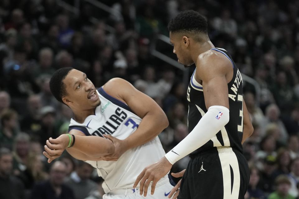 Milwaukee Bucks' Giannis Antetokounmpo argues with Dallas Mavericks' Grant Williams during the first half of an NBA basketball game Saturday, Nov. 18, 2023, in Milwaukee. (AP Photo/Morry Gash)