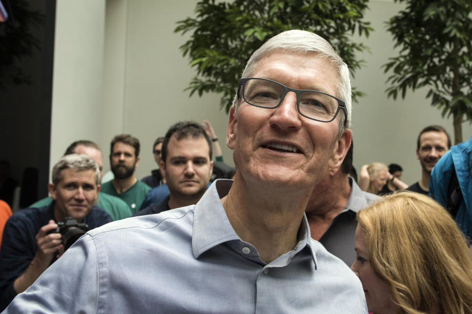 Apple CEO Tim Cook welcomes customers to the company's new store, Apple Carnegie Library, in Washington, Saturday, May 11, 2019. (AP Photo/Cliff Owen)