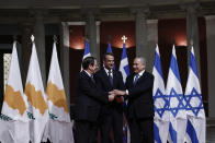 Greece's Prime Minister Kyriakos Mitsotakis, center, Cypriot President Nicos Anastasiadis, left, and Israeli Prime Minister Benjamin Netanyahu pose for a photograph ahead of a signing ceremony in Athens, Thursday, Jan. 2, 2020. The leaders of Greece, Israel and Cyprus met in Athens Thursday to sign a deal aiming to build a key undersea pipeline, named EastMed, designed to carry gas from new rich offshore deposits in the southeastern Mediterranean to continental Europe. (AP Photo)