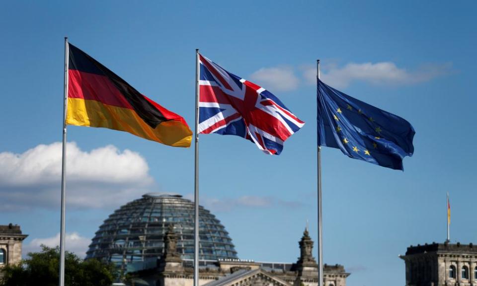 German, British and EU flags fly in front of the Reichstag in Berlin.