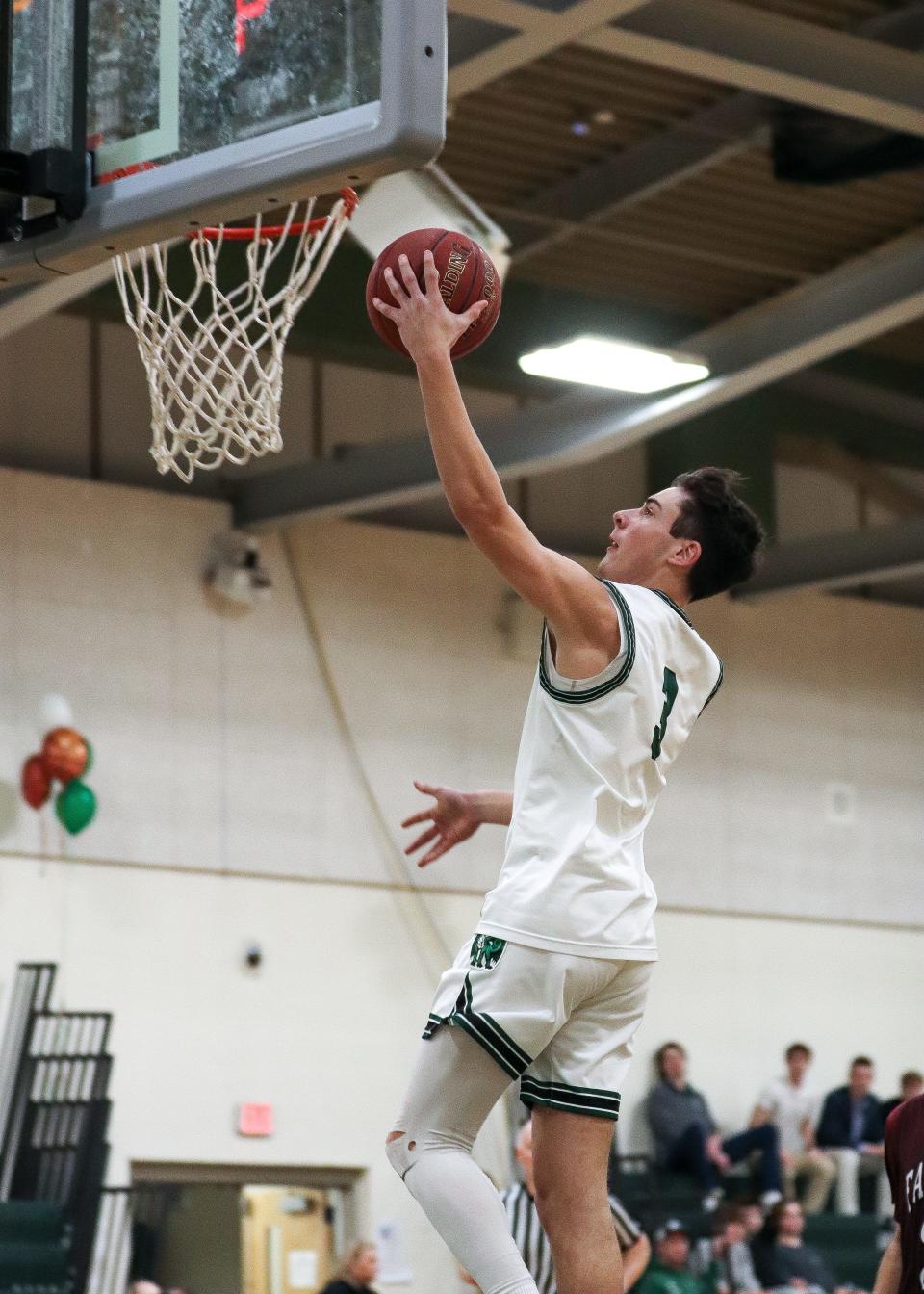 Duxbury's Tate Fiedler lays the ball in during a game against Falmouth on Friday, Feb. 17, 2023.