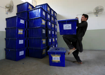 An Afghan election commission worker prepares ballot boxes and election material to send to the polling stations at a warehouse in Jalalabad city, Afghanistan October 19, 2018.REUTERS/Parwiz