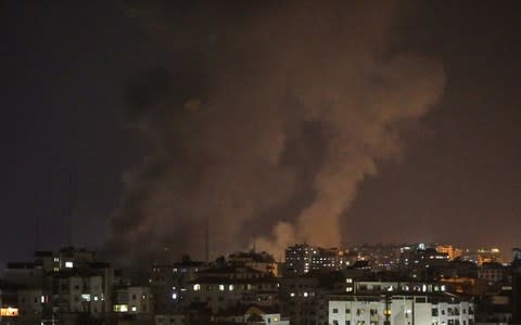 Smoke rises after Israeli army conducted air strikes towards different regions of Gaza City - Credit: Getty