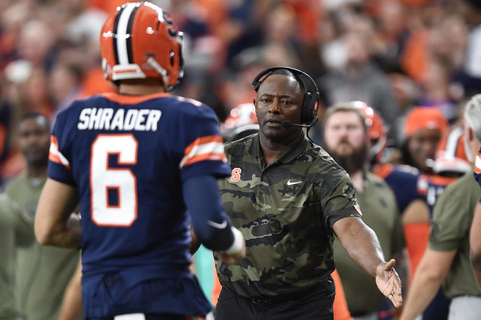 Syracuse head coach Dino Babers, right, congratulates quarterback Garrett Shrader (6) after his rushing touchdown during the second half of an NCAA college football game against Army in Syracuse, N.Y., Saturday, Sept. 23, 2023. (AP Photo/Adrian Kraus)