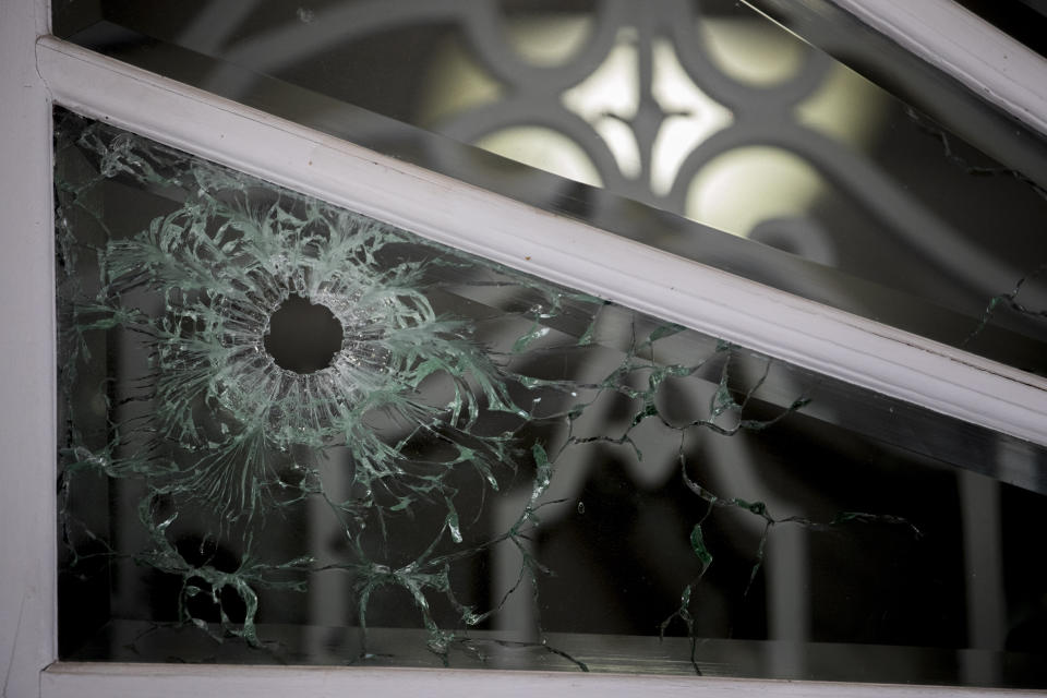 A bullet hole is visible in the front door of the Cuban Embassy in Washington, Friday, May 1, 2020, after a man opened fire with an assault rifle on Thursday morning. Officers found the suspect with an assault rifle and took the person into custody without incident, police said. (AP Photo/Andrew Harnik)