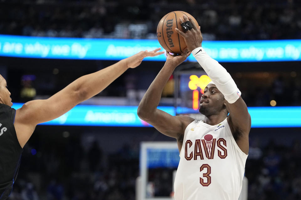 Cleveland Cavaliers guard Caris LeVert (3) shoots against Dallas Mavericks forward Grant Williams during the second half of an NBA basketball game in Dallas, Wednesday, Dec. 27, 2023. (AP Photo/LM Otero)