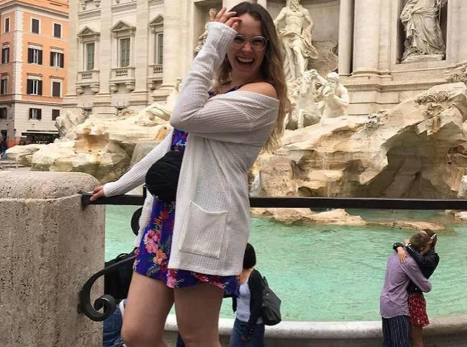 Alycia Savard-Ouellet in front of Trevi Fountain in Italy while a couple kiss behind her.