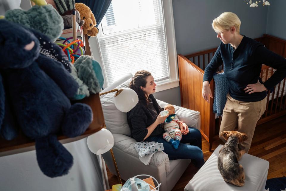 Corinne Rockoff, left, of Ferndale, feeds her son Sawyer Basin breast milk from a bottle while sitting in his room with her wife, Alicia Basin, at their home in Ferndale on Jan. 27, 2023. Rockoff is worried about their parental rights should something happen to one of them or the marriage.