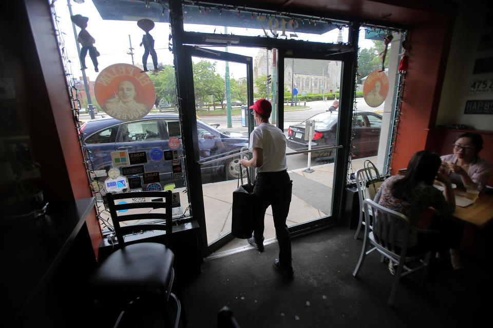 BOSTON - MARCH 15: Jane Bergman, a delivery driver for Grubhub, leaves El Pelon in Boston on March 15, 2015. (Photo by Lane Turner/The Boston Globe via Getty Images)