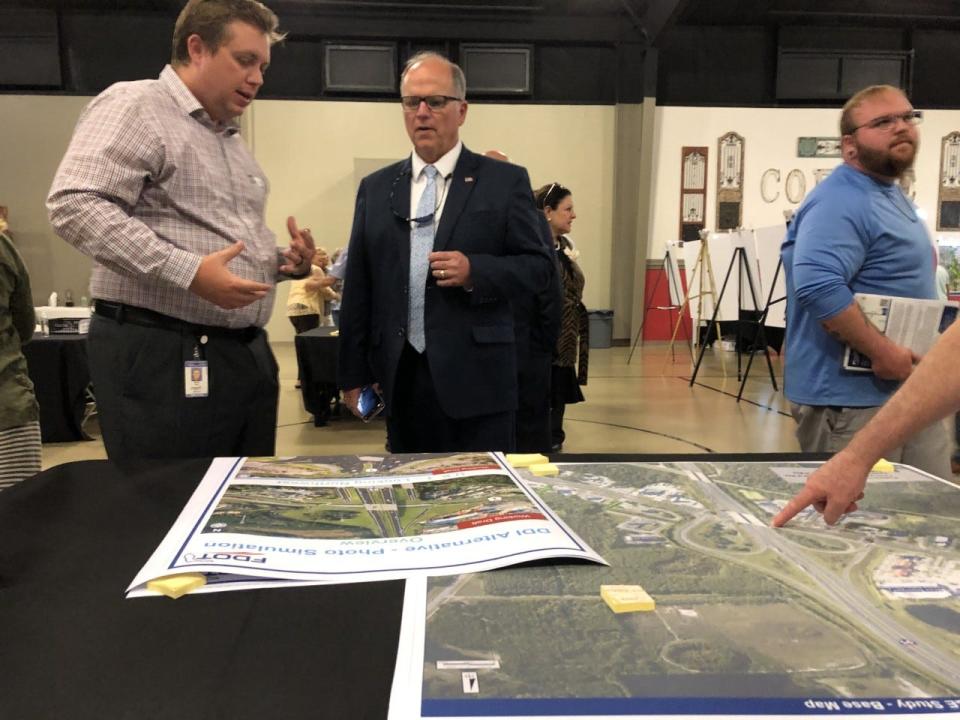 Steven Buck, an engineer with the Florida Department of Transportation, discusses the Interstate 95 interchange with U.S. 1 with Ormond Beach Mayor Bill Partington during a public hearing in Ormond Beach on Tuesday, June 21, 2022.