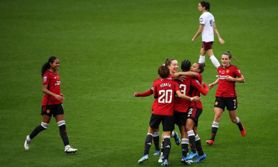 Players celebrate after the Manchester United’s first goal, during the Women’s Super League match between Man United and West Ham United at Leigh Sports Village