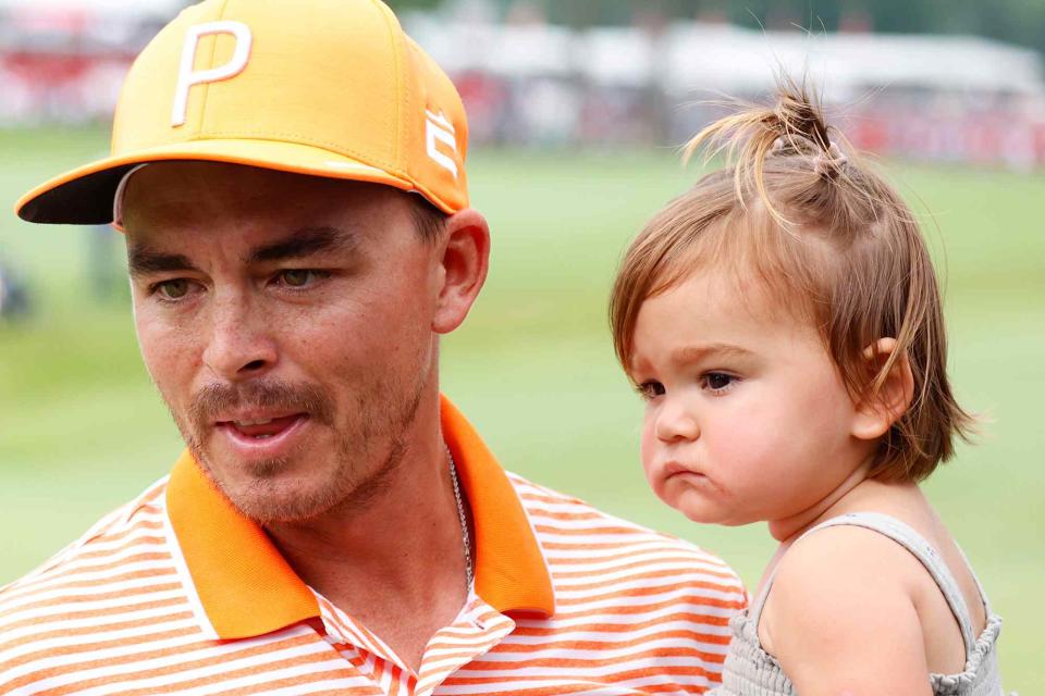 <p>Brian Spurlock/Icon Sportswire/Getty</p> Rickie Fowler holds his daughter Maya Fowler on July 2, 2023 during the final round after winning the Rocket Mortgage Classic.