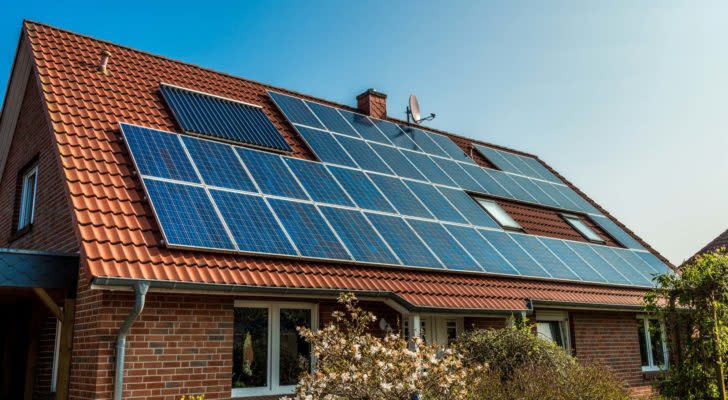 An orange slanted roof covered in solar panels.