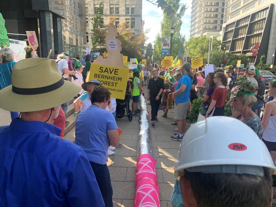 More than 100 people with a fake pipeline gathered in front of Louisville Gas and Electric's downtown office on Friday, Sept. 27, 2019, to protest a proposed pipeline through a section of Bernheim forest.