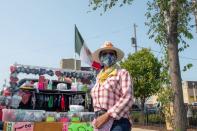 Margarita Garcia, who also refers her artist name Daysy Good, poses for a photograph at her vending stand outside El Rey grocery market in Milwaukee