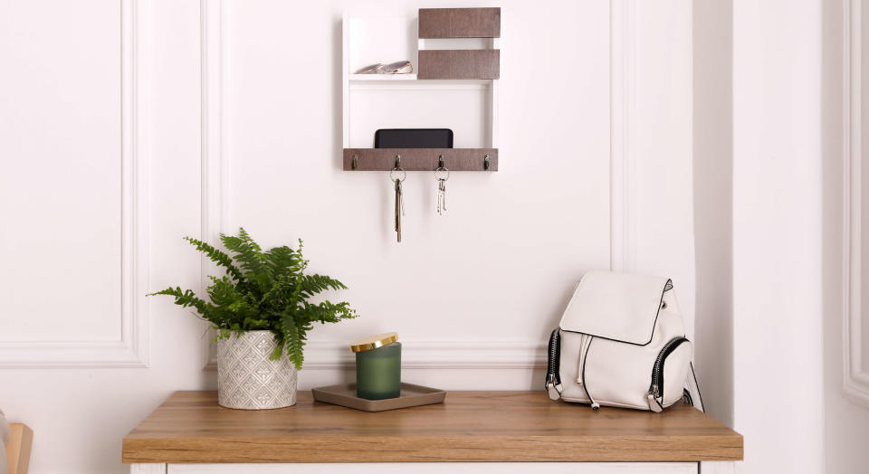 White painted hallway with panelled walls with a console table