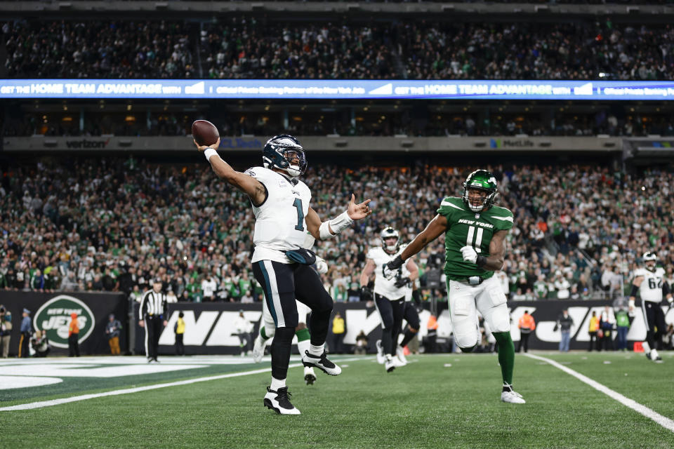 Philadelphia Eagles quarterback Jalen Hurts, left, throws during the second half of an NFL football game against the New York Jets, Sunday, Oct. 15, 2023, in East Rutherford, N.J. (AP Photo/Adam Hunger)