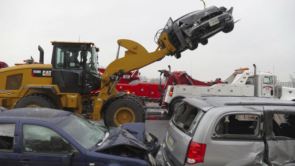 Mangled vehicles rest on the northbound Interstate 95 shoulder at the Washington Boulevard exit after a series of crashes that shut down I-95 in Baltimore, Md., on Saturday, Dec. 17, 2016. An ice storm created slick conditions, sparking a chain reaction pile-up involving dozens of vehicles. (Karl Merton Ferron/The Baltimore Sun via AP)