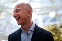 FILE PHOTO: Amazon founder and CEO Jeff Bezos laughs as he talks to the media while touring the new Amazon Spheres during the grand opening in Seattle