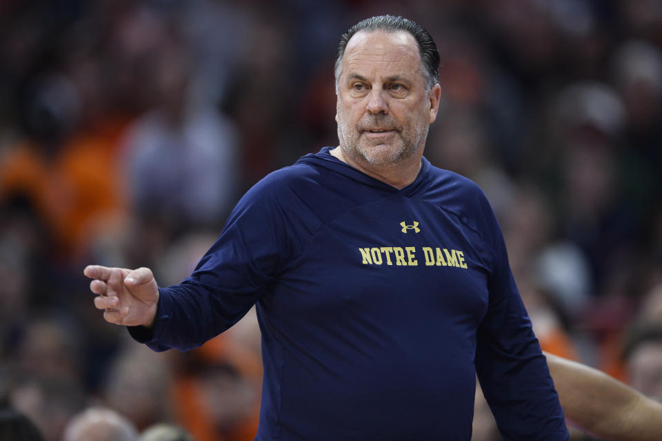 Notre Dame head coach Mike Brey directs players during the first half of the team's NCAA college basketball game against Syracuse in Syracuse, N.Y., Saturday, Jan. 14, 2023. (AP Photo/Adrian Kraus)