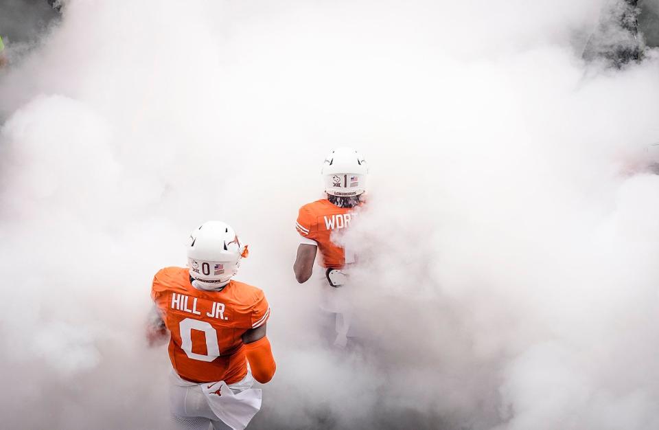 Texas wide receiver Xavier Worthy and linebacker Anthony Hill Jr. make their way onto the field at Royal-Memorial Stadium before a 33-30 overtime win over Kansas State on Nov. 4. The Longhorns, now ranked No. 3 in the country, will face No. 2 Washington in Monday night's Sugar Bowl, a College Football Playoff national semifinal.