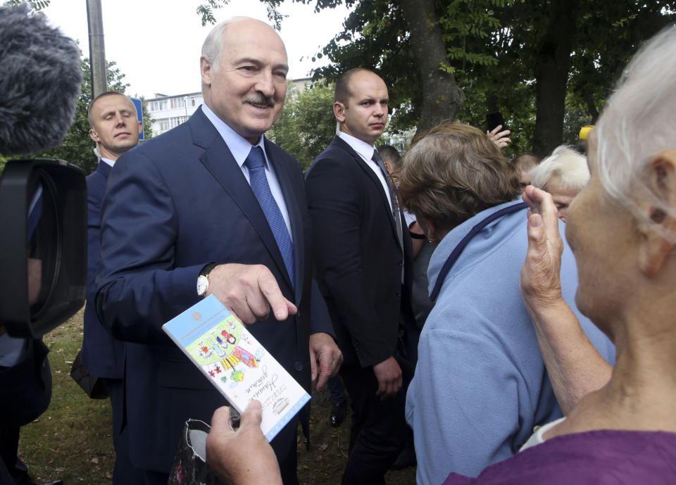Belarusian President Alexander Lukashenko gestures while speaking to local citizens in Baranovichi, 150 km (93 miles) southwest of Minsk, Belarus, Tuesday, Sept. 1, 2020. (Sergei Shelega, BelTA Pool via AP)