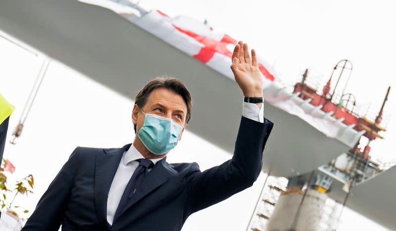 Italian Prime Minister Giuseppe Conte wearing a protective face mask attends the inauguration ceremony of the final section of Genoa's new bridge being installed into place and completing the rebuilding of the structure, in Genoa