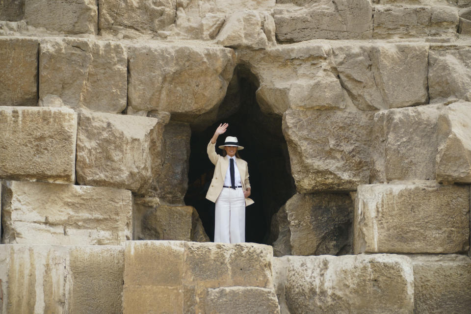 First lady Melania Trump waves before entering the Great Pyramid as she visits the historical site of the Giza Pyramids in Giza, near Cairo, Egypt. Saturday, Oct. 6, 2018. First lady Melania Trump is visiting Africa on her first big solo international trip. (AP Photo/Carolyn Kaster)