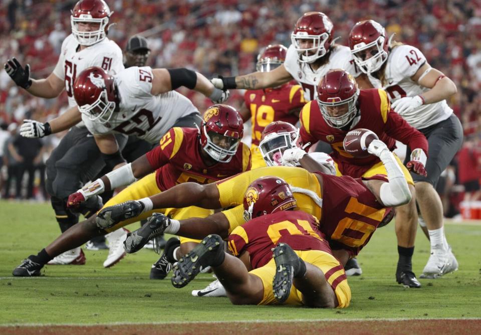 USC linebacker Ralen Goforth strips the ball from Washington State running back Jaylen Jenkins near the end zone