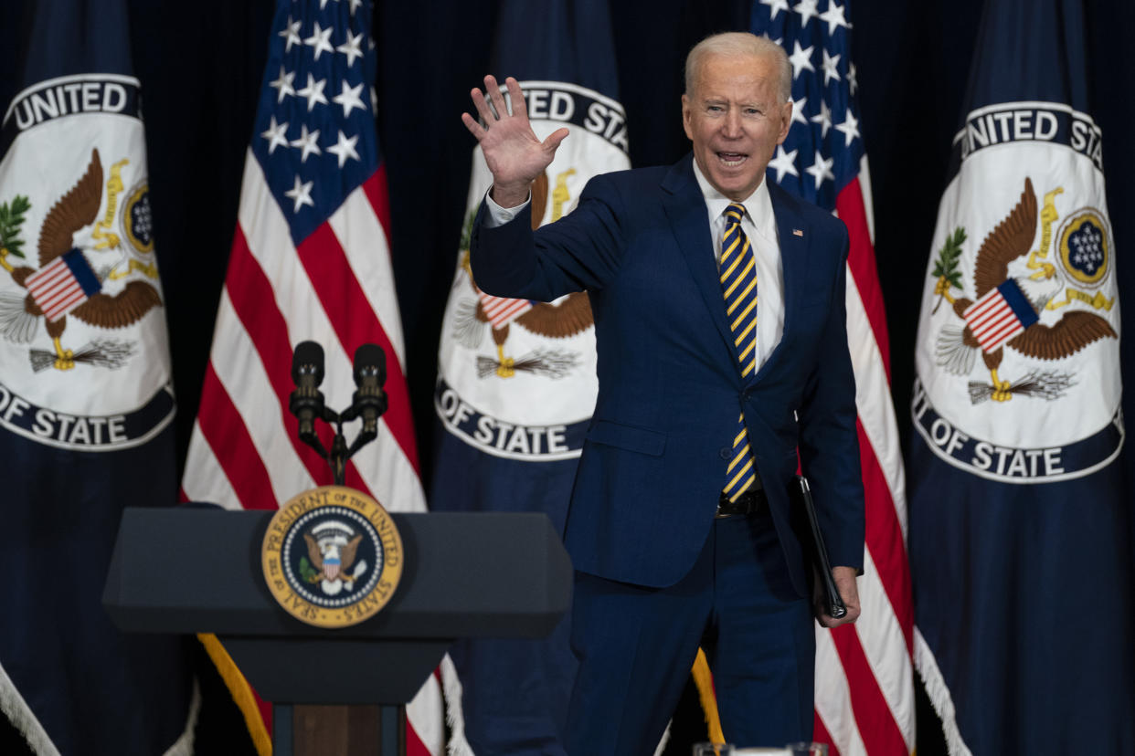 FILE - In this Feb. 4, 2021, file photo, President Joe Biden waves after speaking to State Department staff in Washington. Biden laid out an ambitious agenda for his first 100 days in office, promising swift action on everything from climate change to immigration reform to the coronavirus pandemic.(AP Photo/Evan Vucci, File)