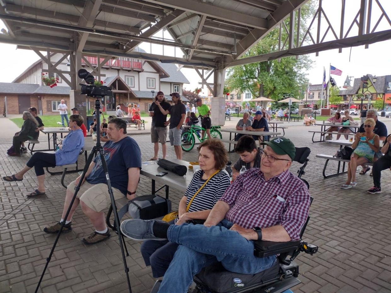 Audience members listen to The Third Degree rock band from Northern Michigan perform June 14 at the Pavilion as part of an effort from musicians to raise funds for those affected by the May 20 tornado in Gaylord.