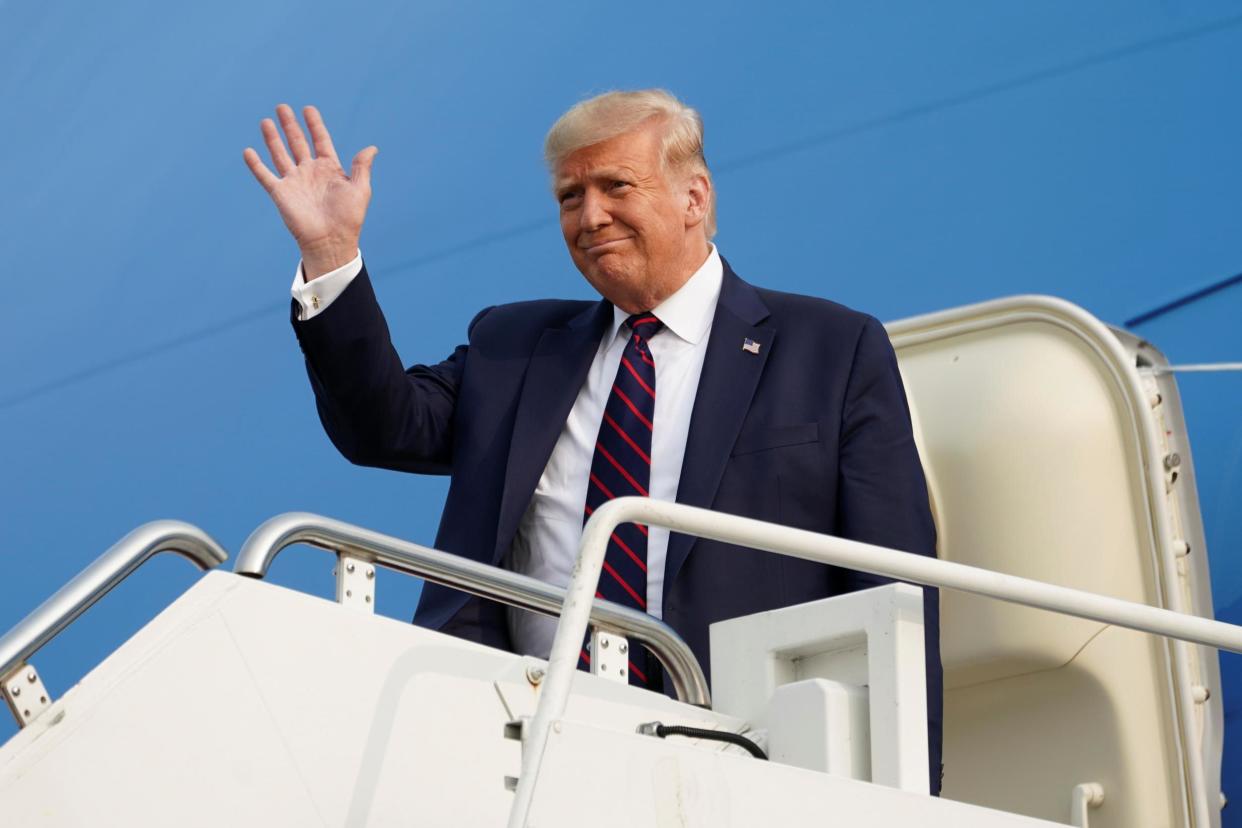 Donald Trump waves from Air Force One as he arrives to attend a town hall campaign event in Philadelphia,: REUTERS