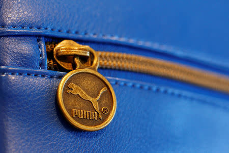 FILE PHOTO: A handbag with the logo of German sports goods firm Puma is pictured in a shop after the company's annual news conference in Herzogenaurach February 20, 2014. REUTERS/Michaela Rehle/File Photo