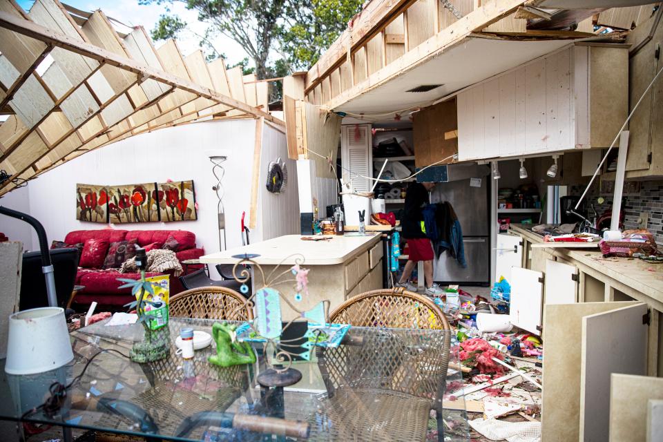 Bob Carrigan retrieves belongings on Monday from a home he rented at Century 21 Mobile Home Park  in Fort Myers. A tornado hit the Iona area in Fort Myers on Sunday.