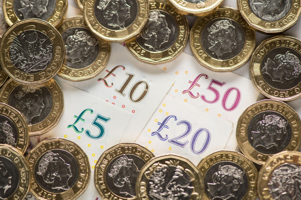 File photo dated 26/01/18 of UK five pound, ten pound, twenty pound and fifty pound notes with one pound coins. Three in four people think Covid-19 will continue to affect their use of cash going into 2021, a survey has found.