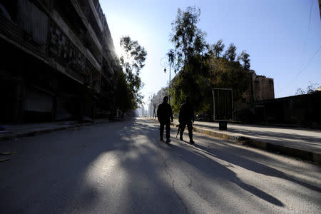 Forces loyal to Syria's President Bashar al-Assad walk along a street in a government held area of Aleppo, Syria December 9, 2016. REUTERS/Omar Sanadiki