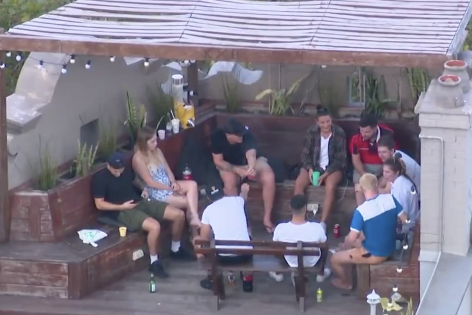 The backpackers were shown socialising in close proximity to each other on the hostel's rooftop. Source: 7 NEWS