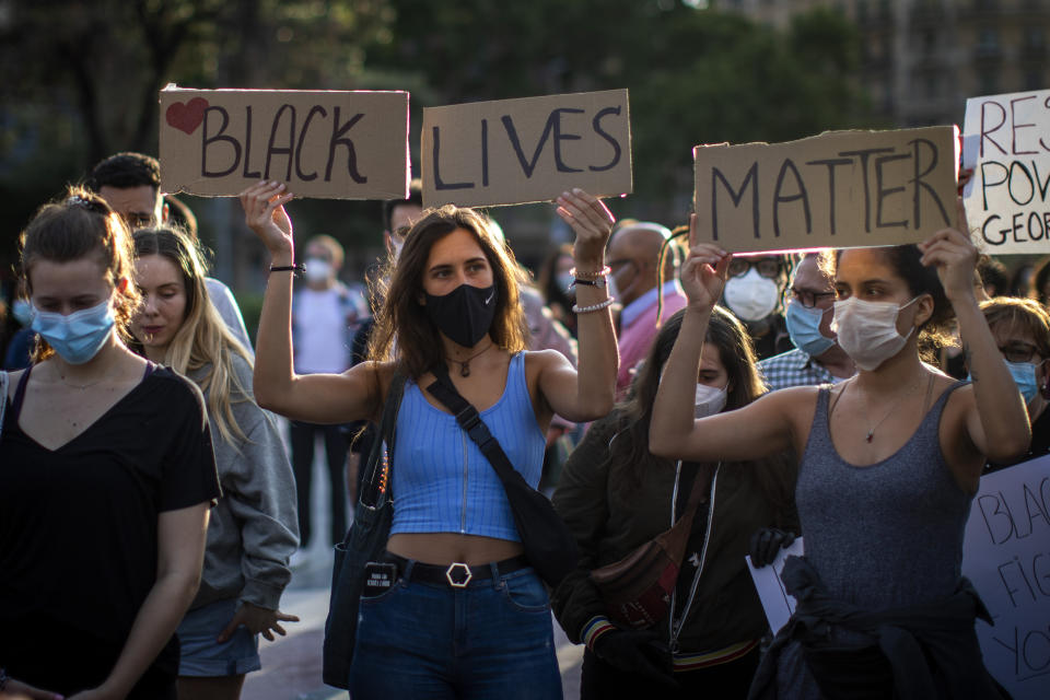 People gather in Barcelona, Spain, Thursday, June 4, 2020, during a demonstration over the death of George Floyd, a black man who died after being restrained by Minneapolis police officers on May 25. (AP Photo/Emilio Morenatti)