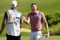 Cameron Smith celebrates with caddy Sam Pinfold after winning the final round of the Tournament of Champions golf event, Sunday, Jan. 9, 2022, at Kapalua Plantation Course in Kapalua, Hawaii. (AP Photo/Matt York)