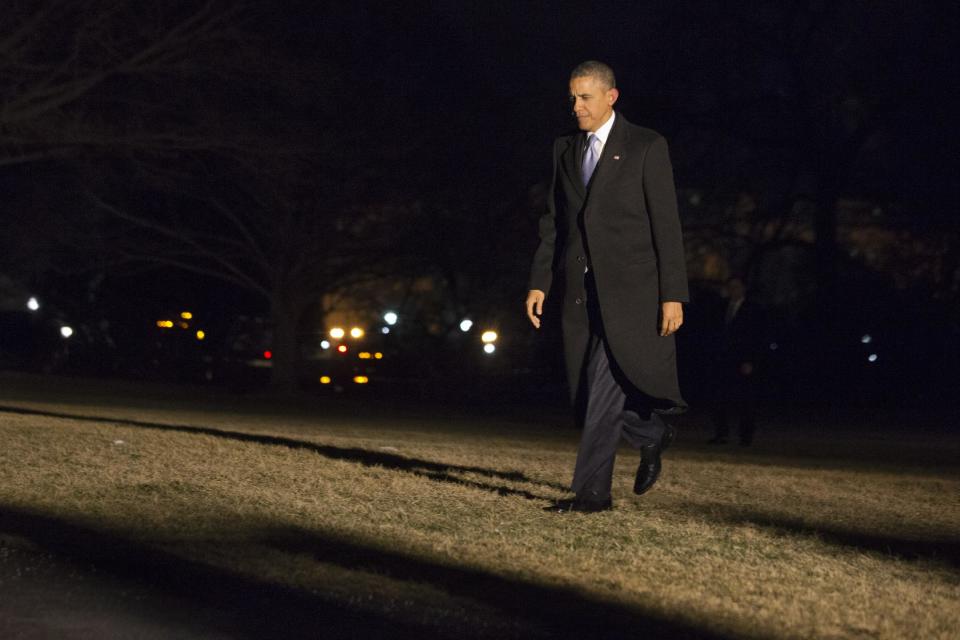 President Barack Obama walks across the South Lawn as he returns from stops in Wisconsin and Tennessee, to the White House in Washington, Thursday Jan. 30, 2014. (AP Photo)