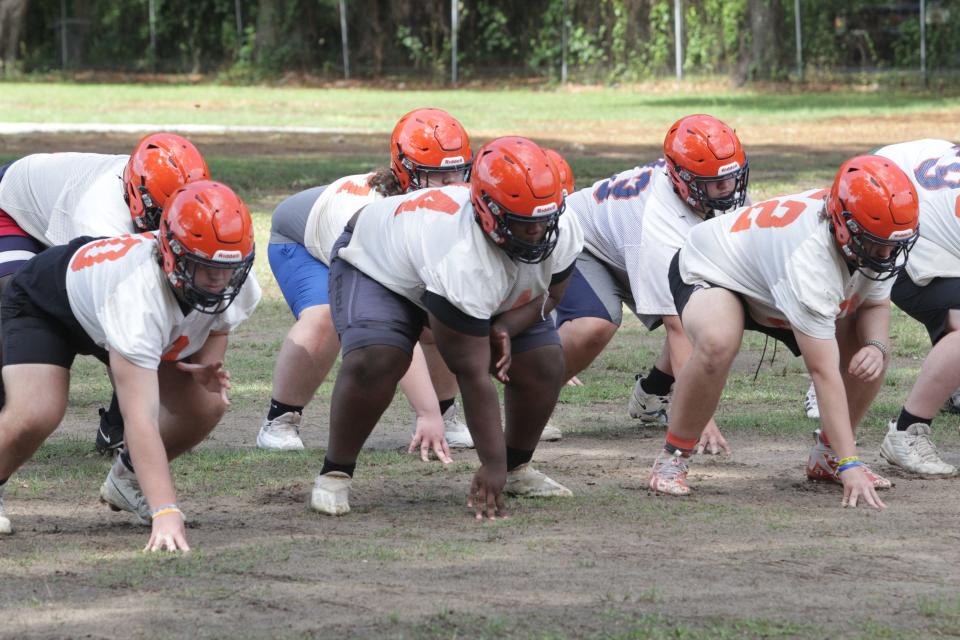 Members of the offensive line perform a drill during the Escambia football team's spring practice on Tuesday, April 30, 2024.