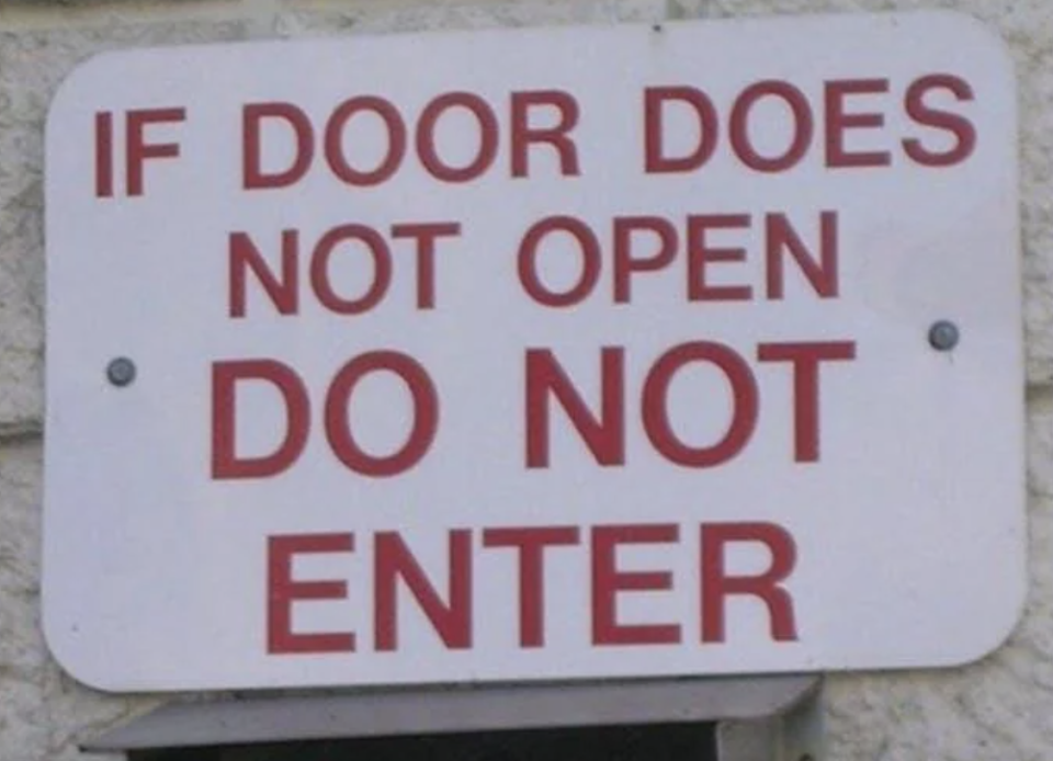 Sign reads "IF DOOR DOES NOT OPEN DO NOT ENTER," highlighting an amusingly obvious instruction