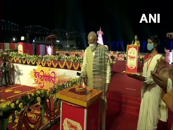 Prime Minister Narendra Modi lighting a lamp to launch Dev Deepwali Mahtosav in Varanasi on Sunday. (Photo/ANI)