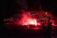 <p>A group of people run as fireworks are lit on the street during a demonstration at Barquisimeto, Venezuela, May 5, 2017. Reports state death toll in the Venezuelan protests increased to 34 after another young man was killed in Caracas on 03 May amid escalating tensions provoked by the government’s call for a rewrite of the constitution. (Photo: Pasquale Giorgio/EPA) </p>