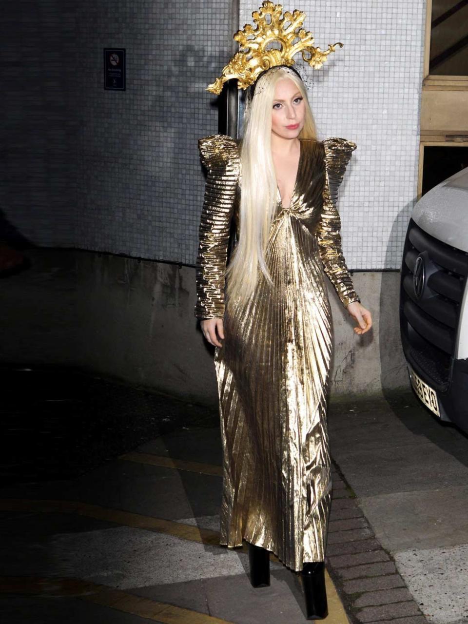 <p>Lady Gaga out and about in London wearing a gold gown with crown, December 2013.</p>