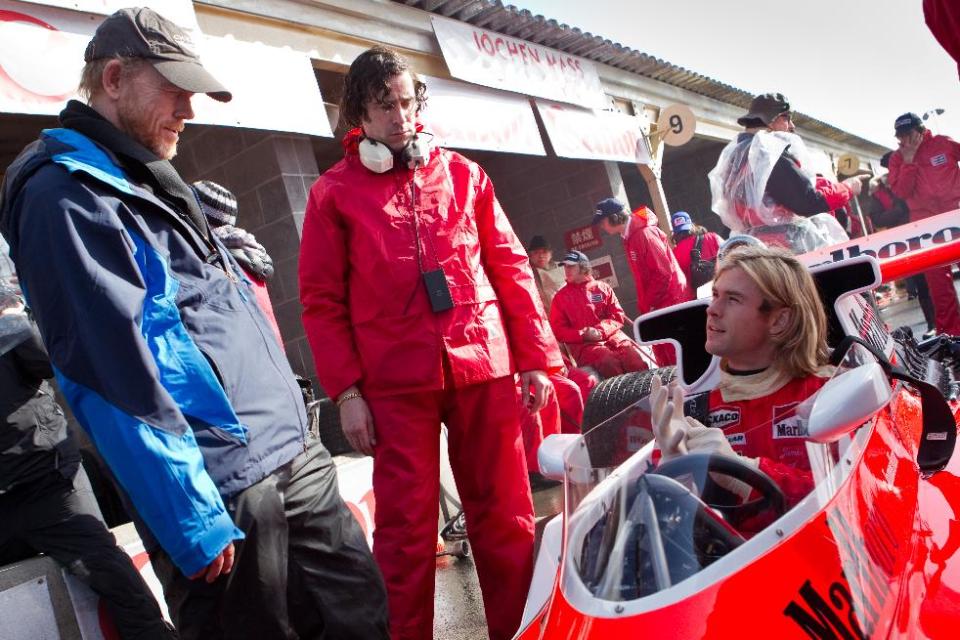 This image released by Universal Pictures shows director Ron Howard, left, and Chris Hemsworth on the set of "Rush." The film, chronicling Formula One's 1976 world championship between Niki Lauda and James Hunt, opens nationwide on Friday, Sept. 27. (AP Photo/Universal Pictures, Jaap Buitendijk)