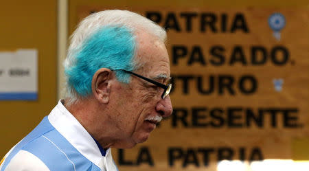 A man named Jorge Williams, with his hair painted in the colours of Argentine national flag, arrives at a polling station during mid-term primary elections in Buenos Aires, Argentina August 13, 2017. REUTERS/Marcos Brindicci