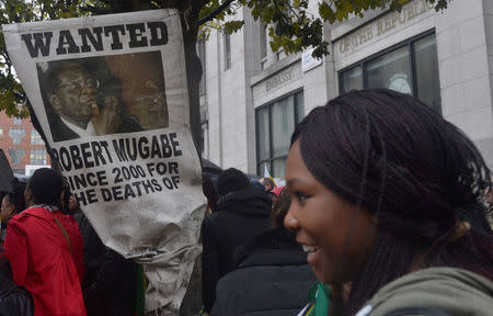 Protesters calling for Zimbabwean President Robert Mugabe to step down gather outside the Zimbabwe Tourist Information Centre in central London, Britain November 18, 2017. REUTERS/Mary Turner