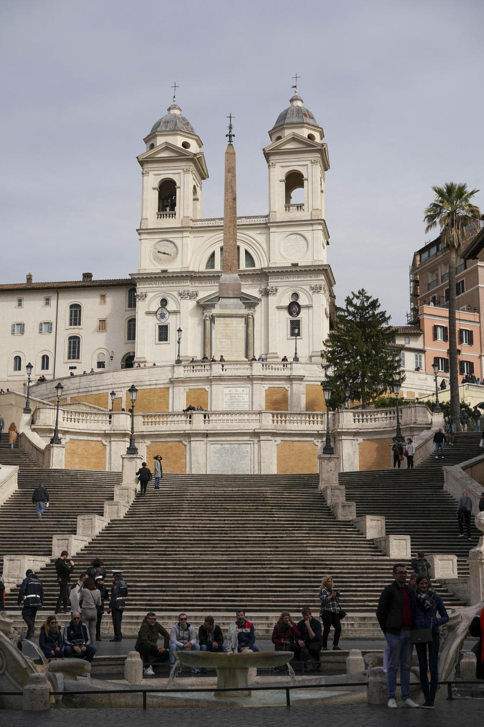 Few tourists gather at the Spanish Steps, in Rome, Thursday, March 5, 2020. Italy's virus outbreak has been concentrated in the northern region of Lombardy, but fears over how the virus is spreading inside and outside the country has prompted the government to close all schools and Universities nationwide for two weeks. (AP Photo/Andrew Medichini)