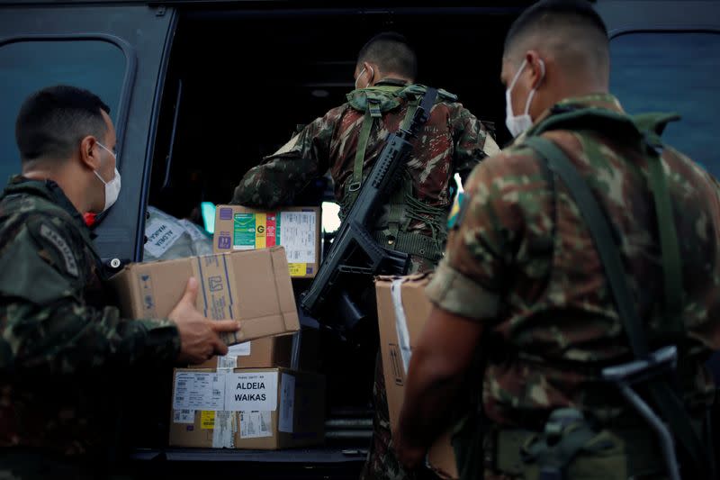 Members of the Brazilian Armed Forces load medical supplies to a military helicopter, amid the spread of the coronavirus disease (COVID-19), in Boa Vista